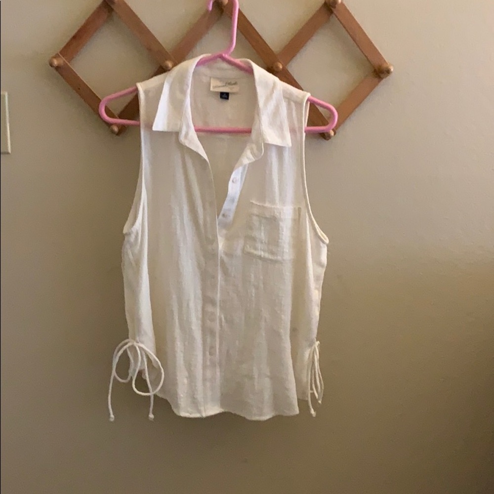 Sleeveless top with side tie detail.